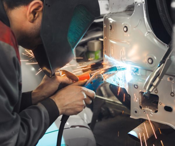 Industrial,Worker,At,Car,Service,Welds,Automotive,Body.,Metalworking,With